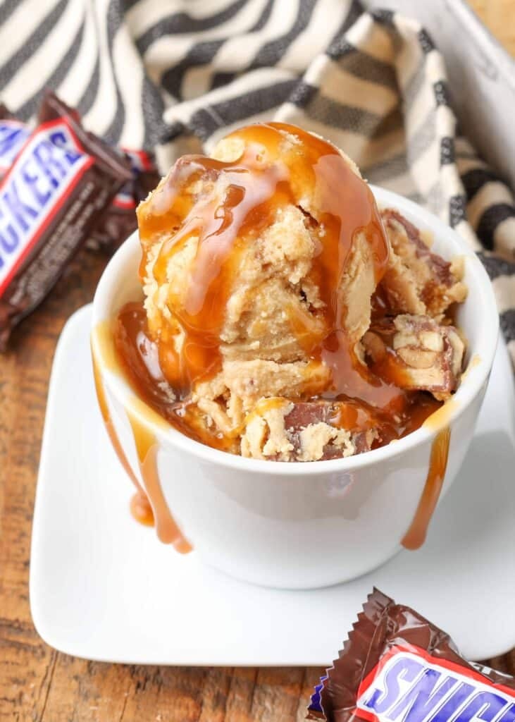 peanut butter ice cream with chunks of snickers candy bars and a caramel swirl