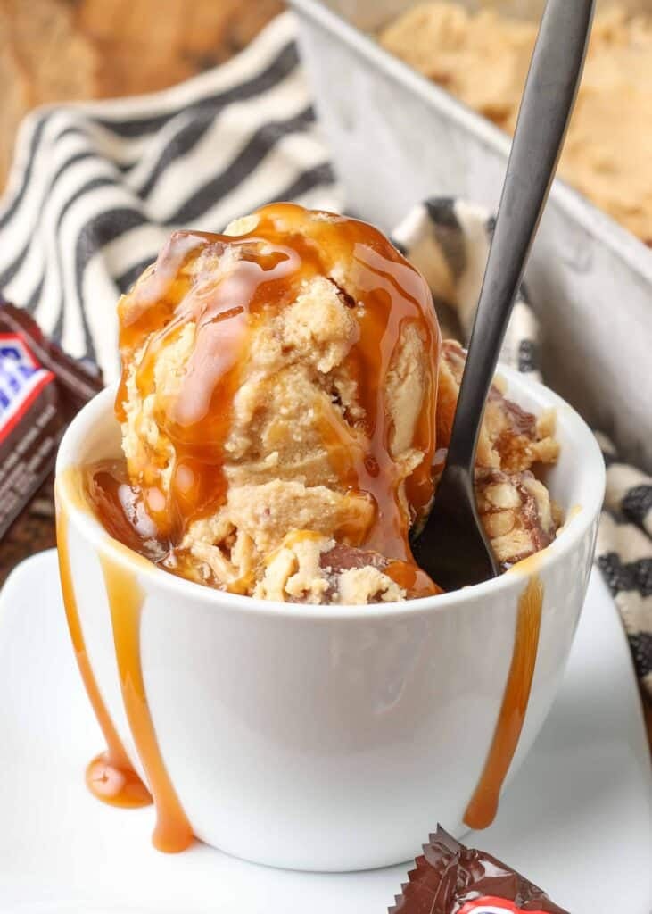 peanut butter ice cream with chunks of snickers candy bars and a caramel swirl