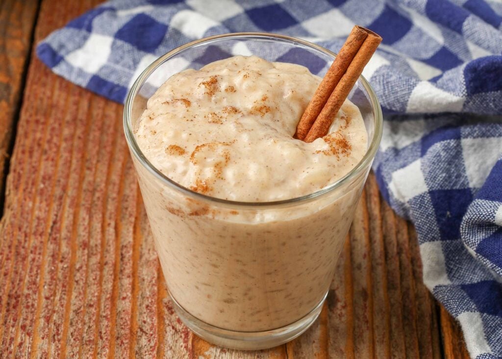 rice pudding in clear glass with cinnamon stick