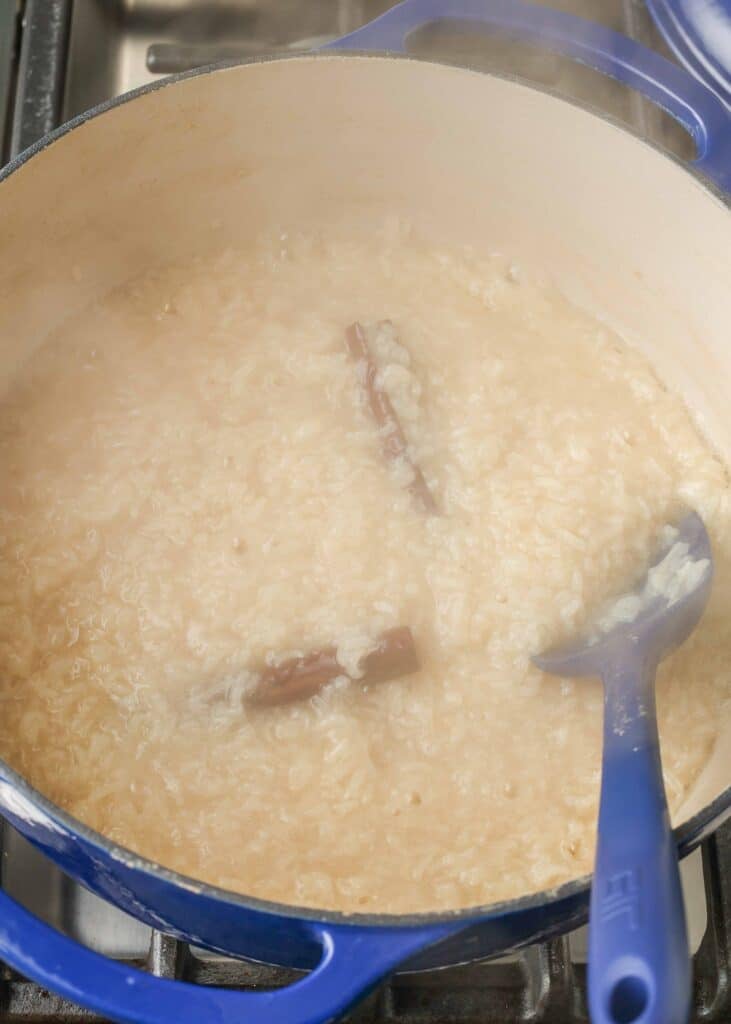 thickening rice pudding in large blue pot