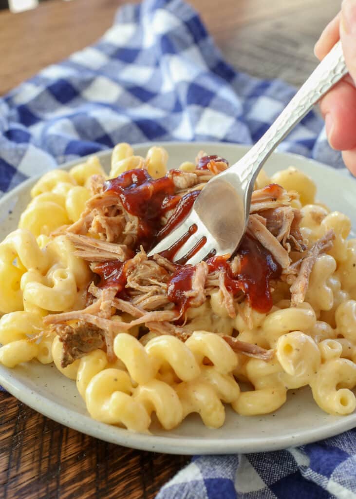 Creamy Mac and Cheese topped with BBQ Pulled Pork is a dinner favorite!