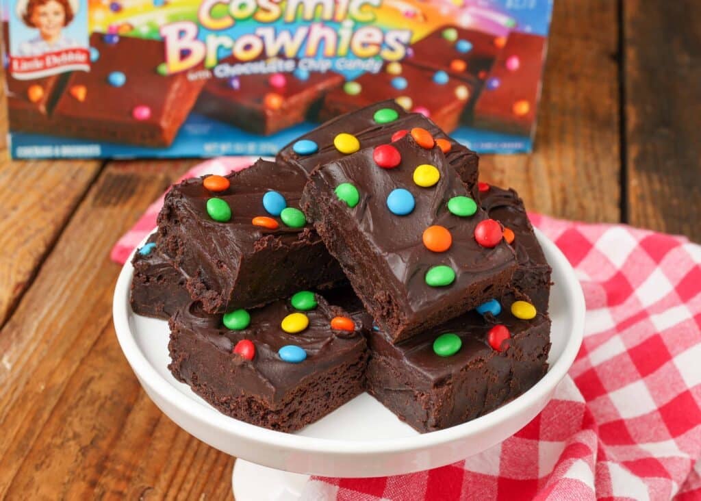 brownies stacked on white stand with m&ms on top