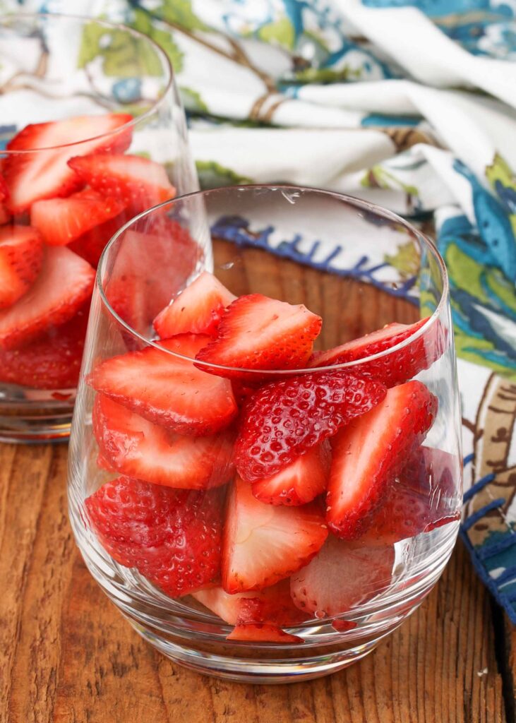 fresh strawberries in clear glasses with blue napkin