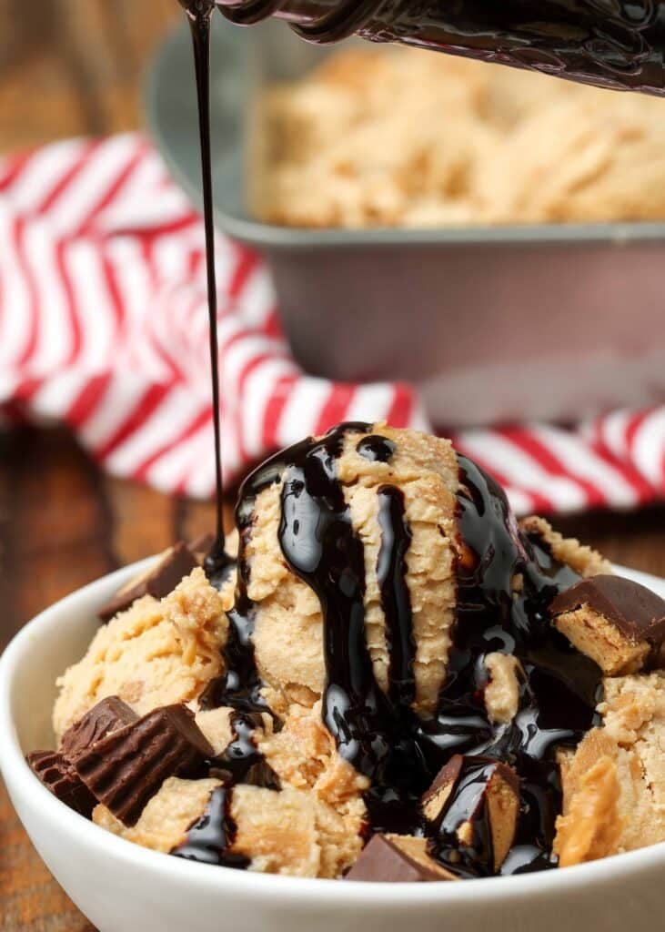 chocolate sauce poured over bowl of ice cream