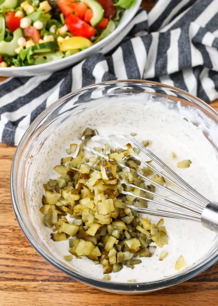stirring dill pickles into ranch dressing - 7