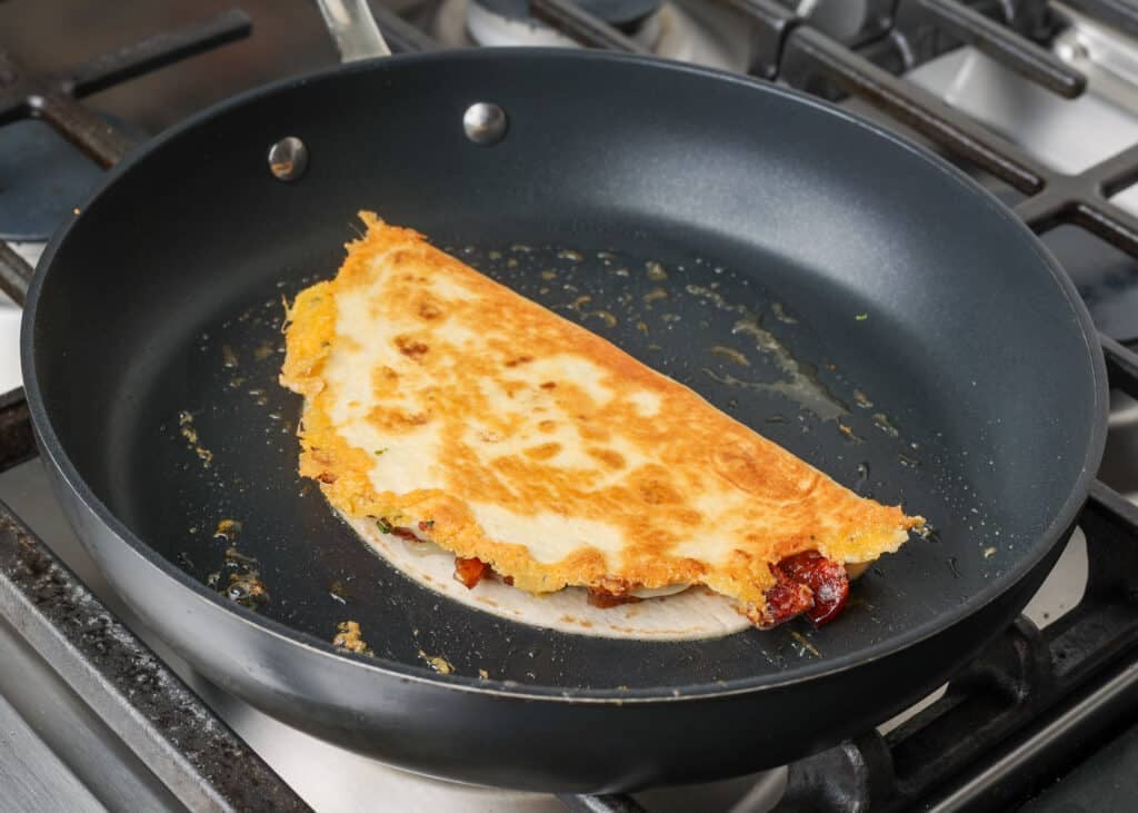 Both sides of the quesadilla are crispy golden brown, and it is ready to remove from the pan.