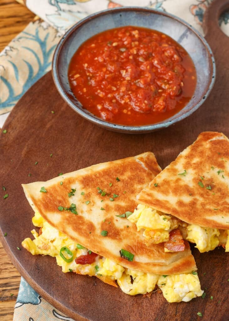 A close up shot of the quesadilla wedges from above, showing the crispy tortilla and the fillings peeking out from the edge.