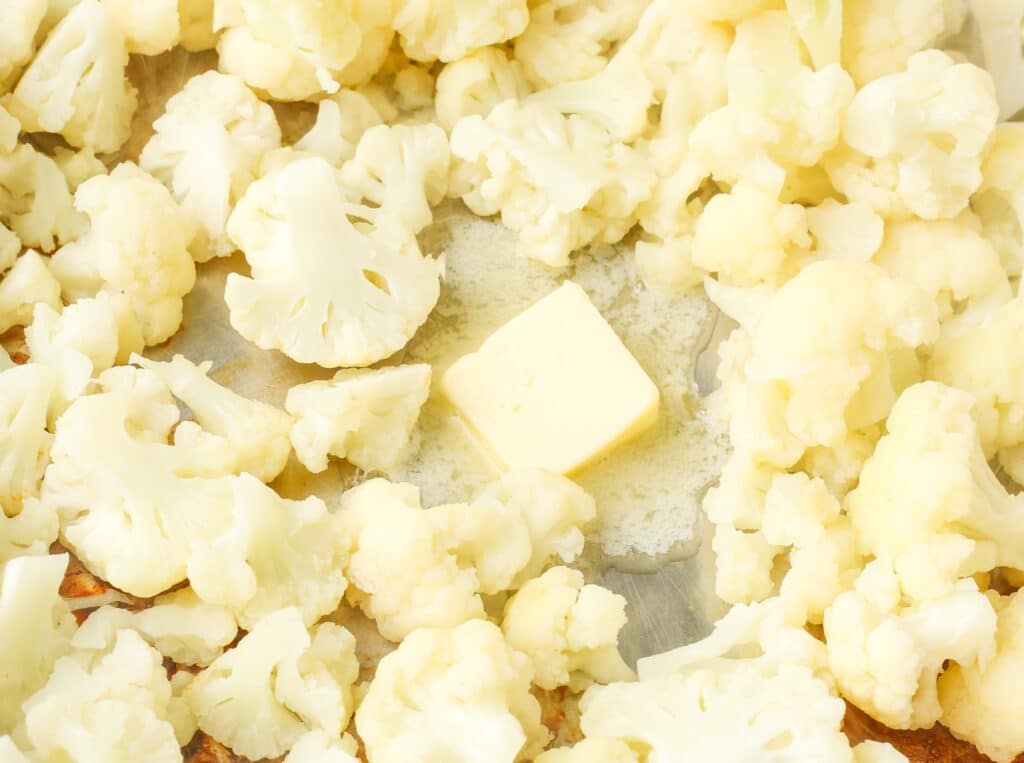 adding butter to cauliflower