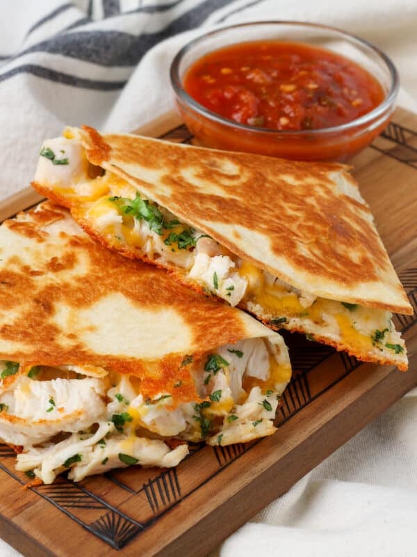 close up of chicken quesadilla on board with salsa