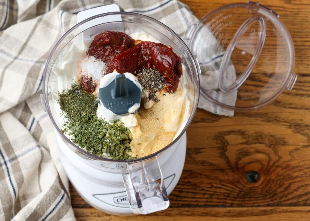 All of the fresh and dry ingredients have been added to the food processor in a colorful array.