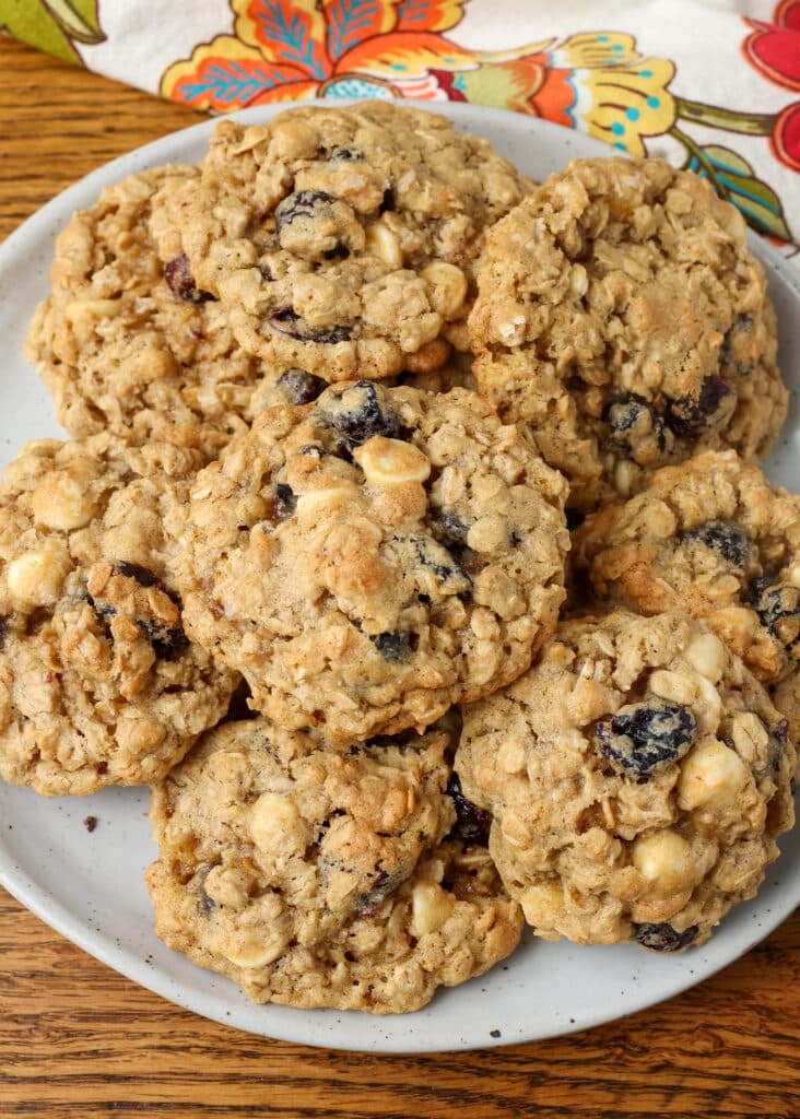 plate of stacked cranberry white chocolate chip cookies on table