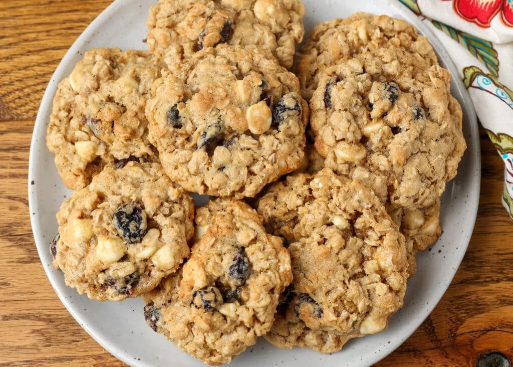 white chocolate chip and cranberry oatmeal cookies on plate on wooden table
