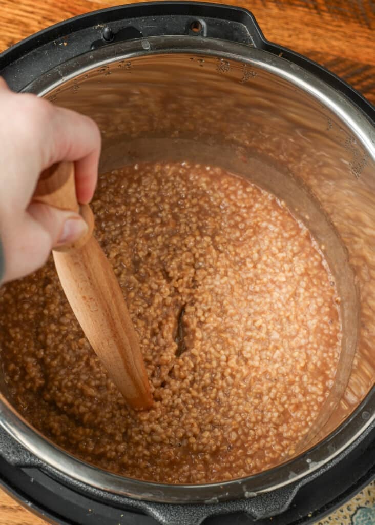 stirring steel cut oats in instant pot with a spurtle