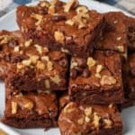 A close up shot of the brownies showing all the walnut pieces in top and within the brownie edges.