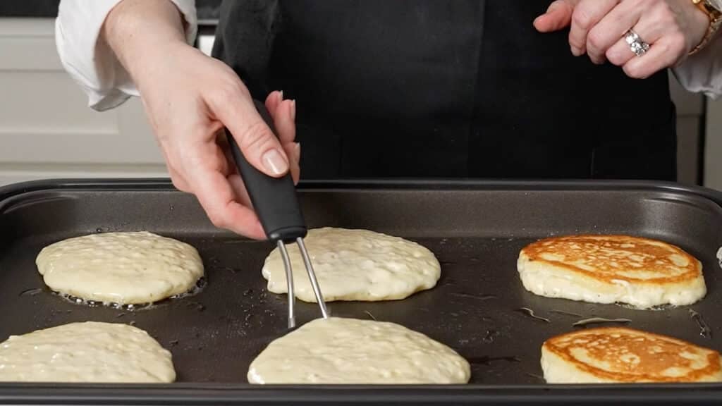 flipping pancake on griddle