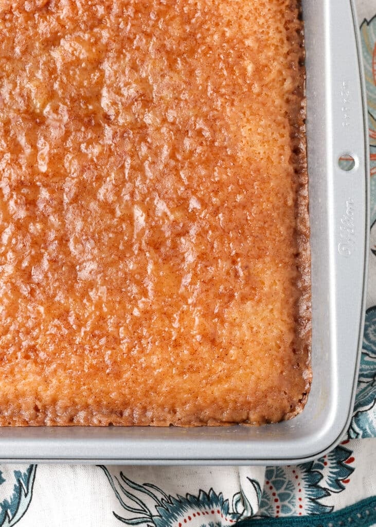 A close up of the cinnamon topping, fresh from the oven, showing crispy edges along the pan.