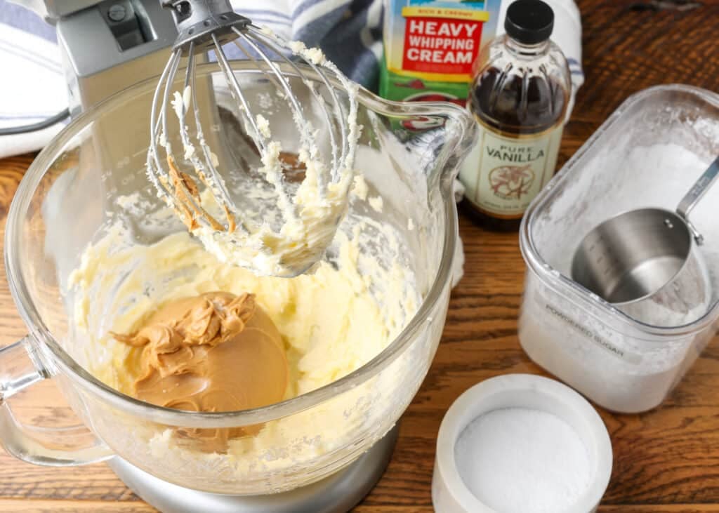 Adding the peanut butter to the stand mixer.