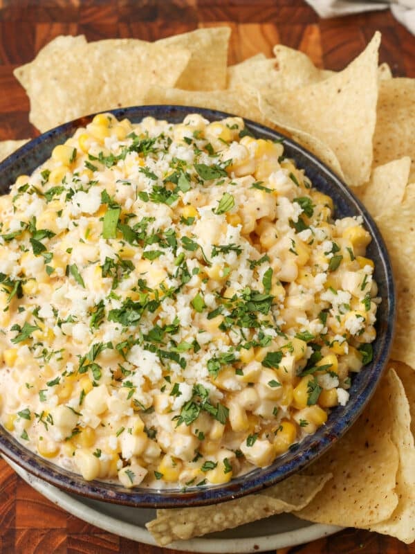 close up overhead photo of Elote Corn Dip with tortilla chips around the bowl