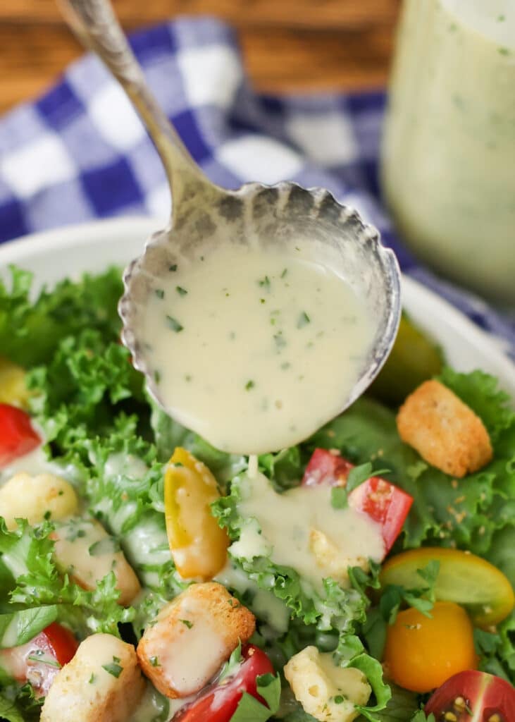 pouring dressing over salad 