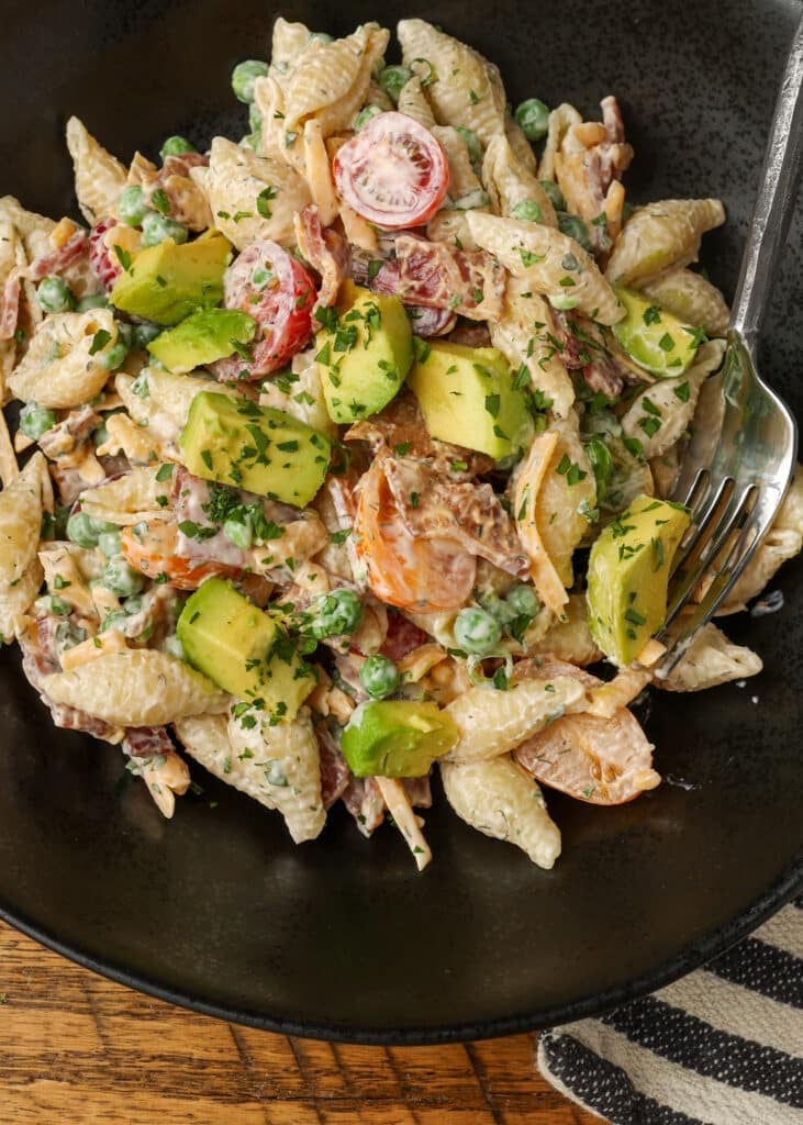 individual serving of bacon ranch pasta salad in black pottery bowl