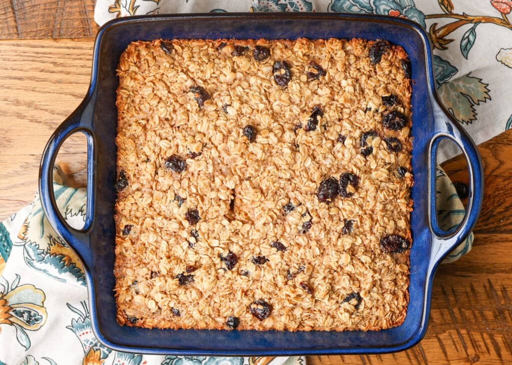cooked oatmeal in blue pan on wooden table