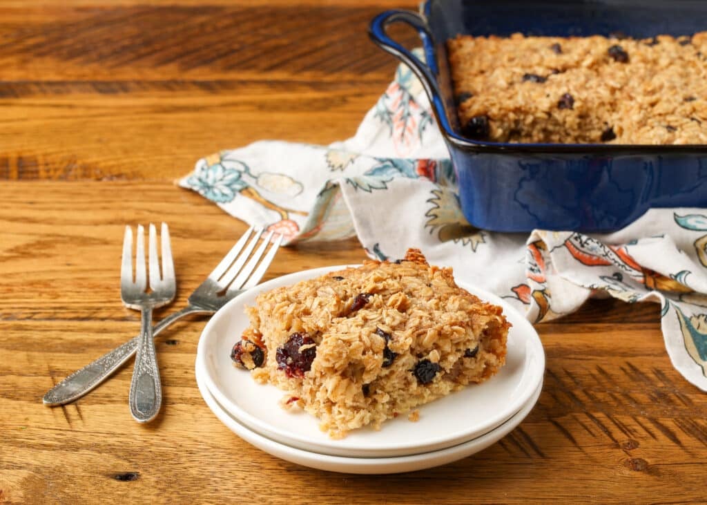baked oatmeal on white plate with forks next to it on table