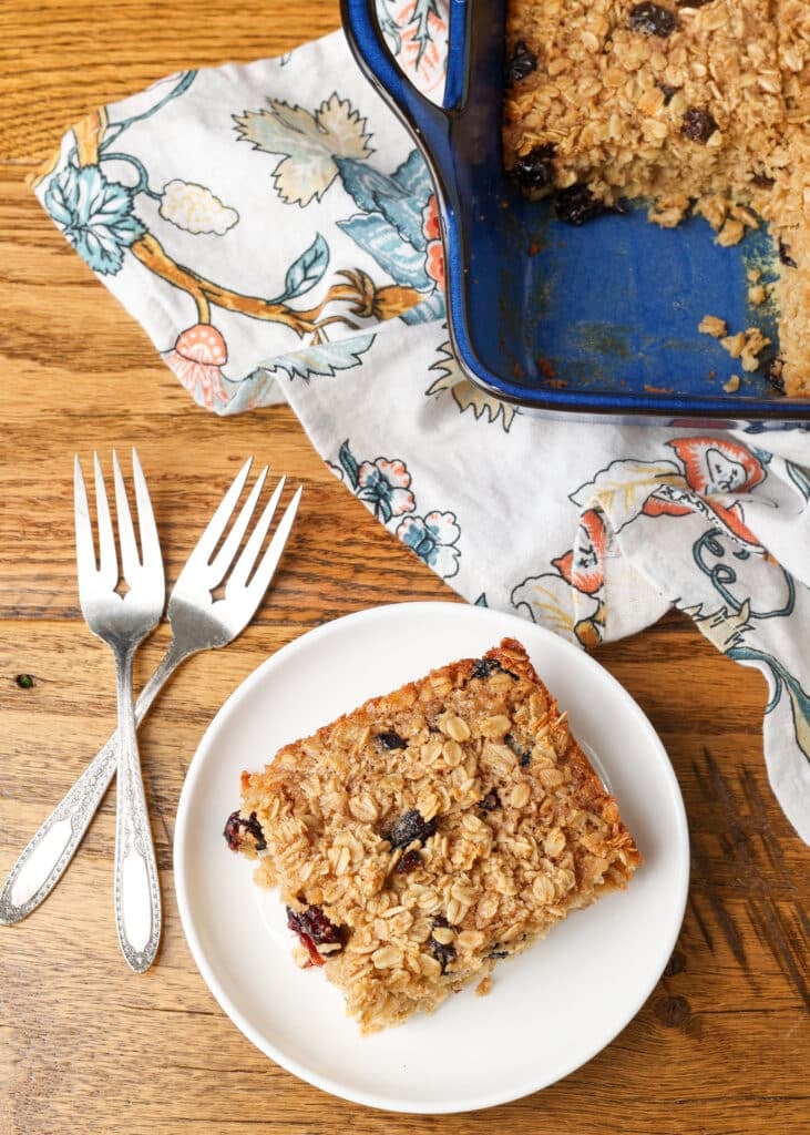 baked oatmeal sliced on white plate with forks next to it