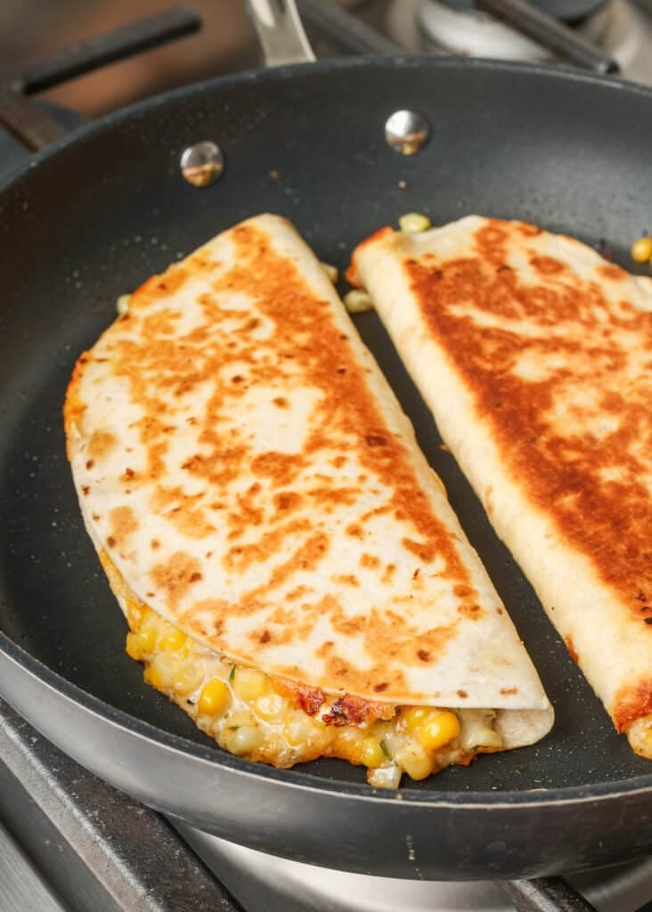 cooked quesadilla with corn on the stove