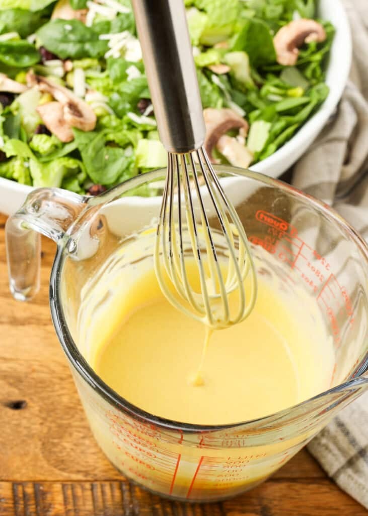 honey mustard dressing on whisk