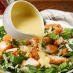 pouring dressing over salad
