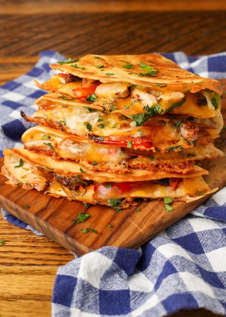 chicken, peppers, and onions in a cheesy quesadilla