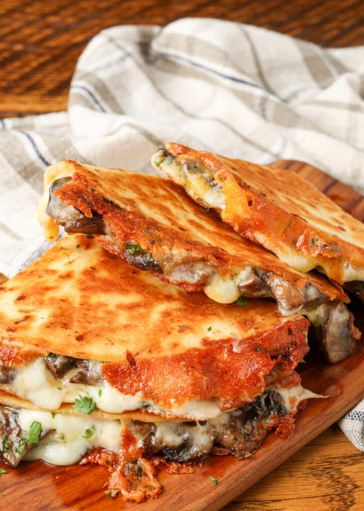 mushroom quesadillas stacked on board