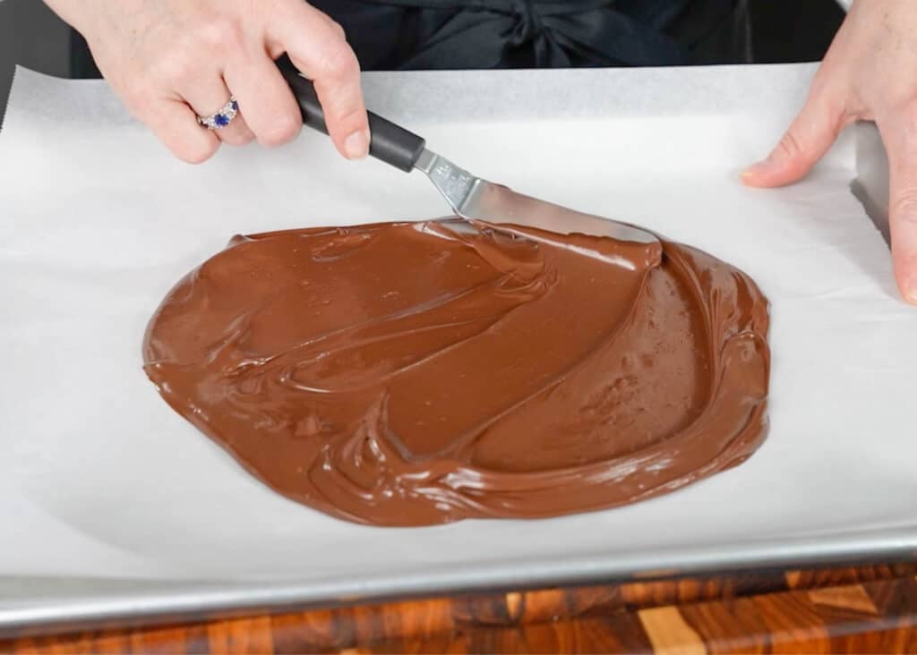 spreading the chocolate across the parchment