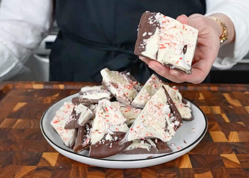a piece of peppermint bark in hand