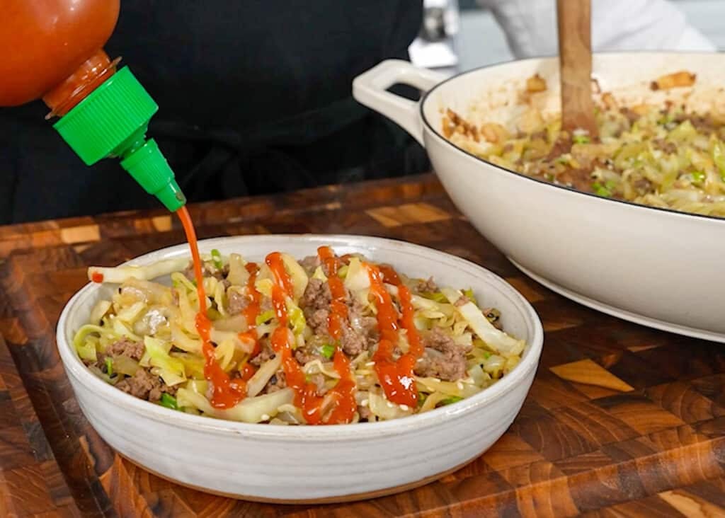 drizzling Sriracha over serving
