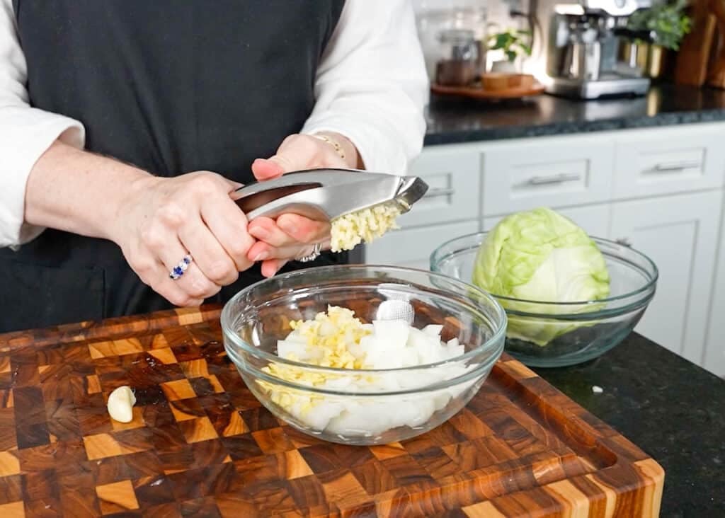 minced garlic into bowl with onion