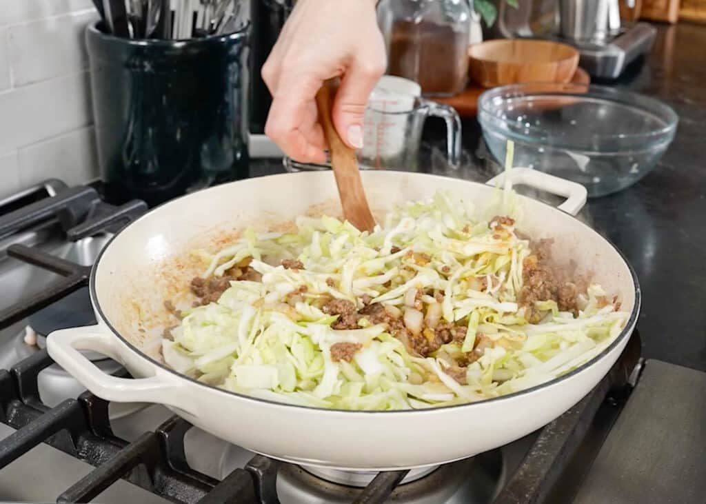 adding cabbage to stir fry