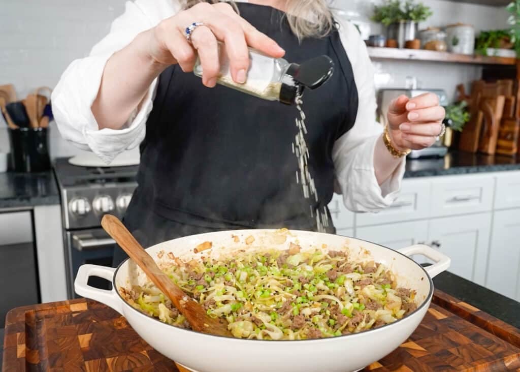 adding sesame seeds to stir fry